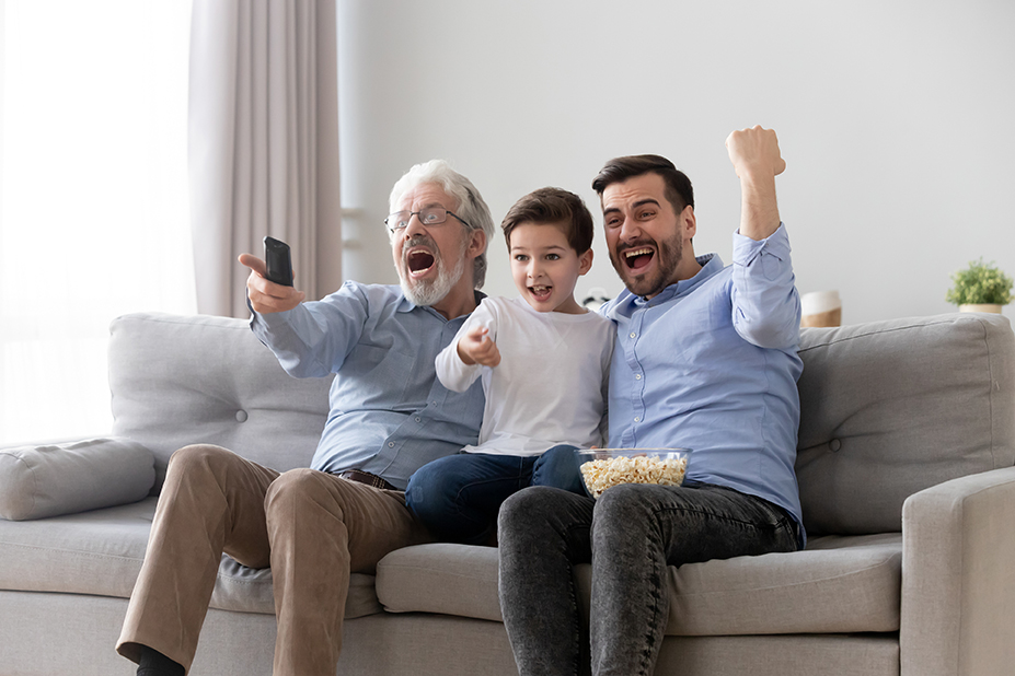 Excited three generation men family watch tv sport game